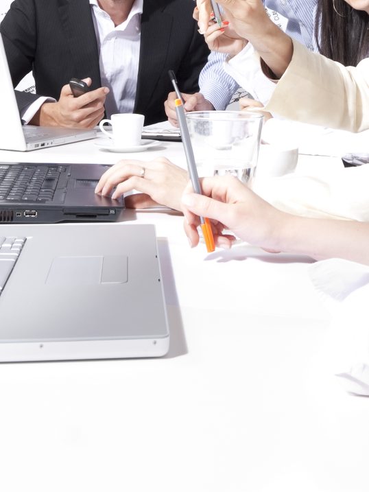 Some people sitting around a table having an animated conversation